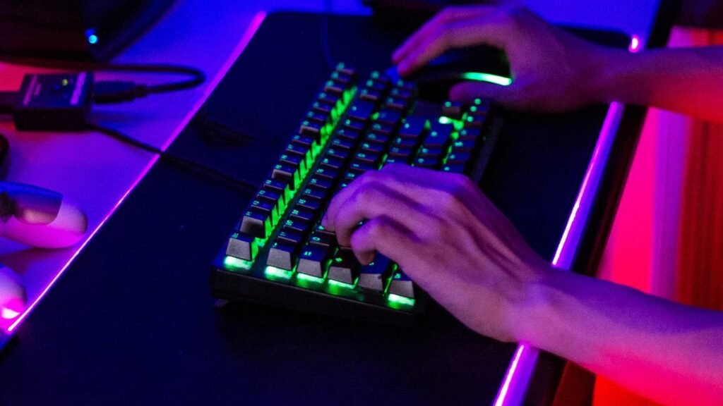 Gamer pressing multiple keys on a keyboard showing responsive gaming technology