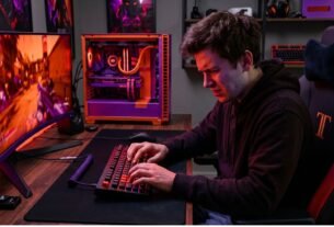 Beginner gamer using a gaming keyboard incorrectly at a modern PC gaming setup